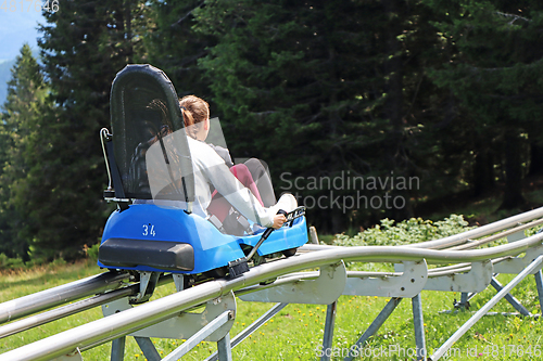 Image of Two young girls enjoying a summer fun roller alpine coaster ride