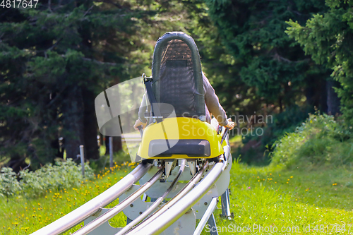 Image of Young girl enjoying a summer fun roller alpine coaster ride