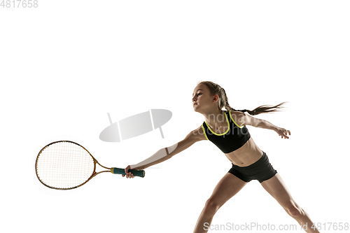 Image of Little caucasian girl playing tennis isolated on white background