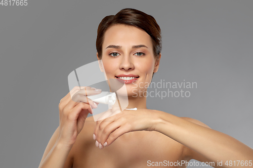 Image of woman applying moisturizing cream to her hand