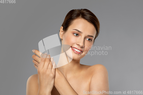 Image of woman applying moisturizing cream to her hand