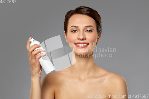 Image of beautiful young woman with hair spray or mist