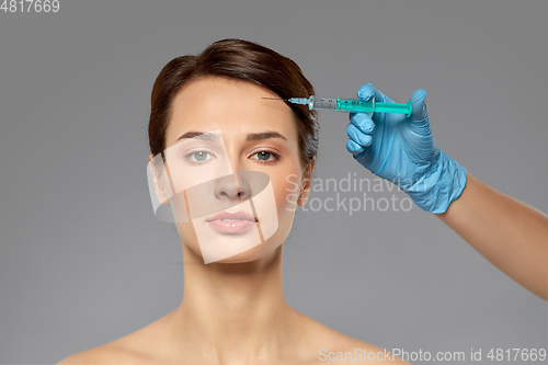 Image of beautiful young woman and hand with syringe