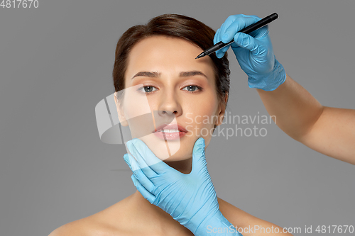 Image of beautiful young woman and hands with marker