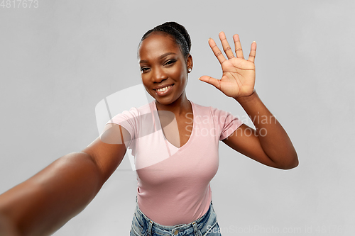 Image of happy african american woman taking selfie