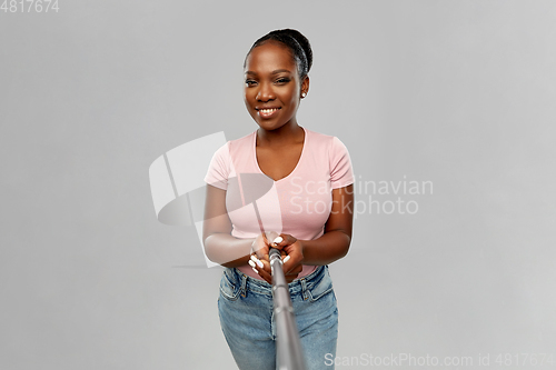 Image of happy african american woman taking selfie