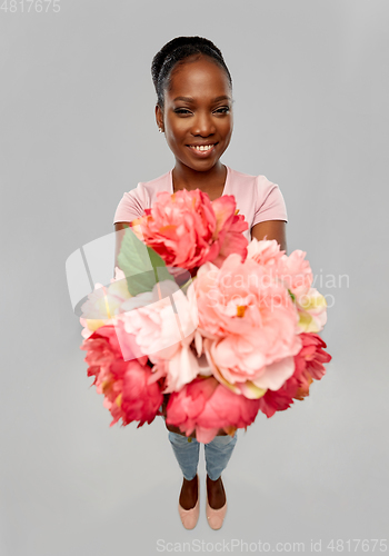 Image of happy african american woman with bunch of flowers