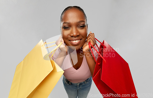 Image of happy african american woman with shopping bag