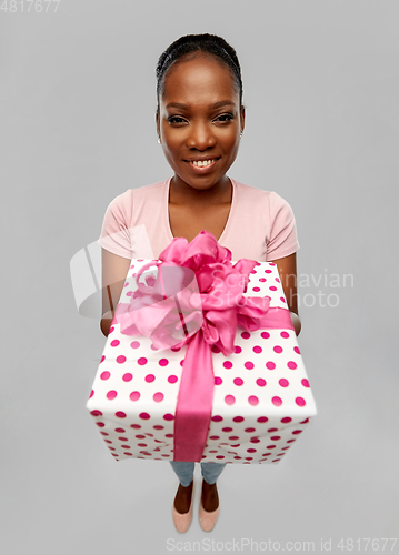 Image of happy african american woman with gift box