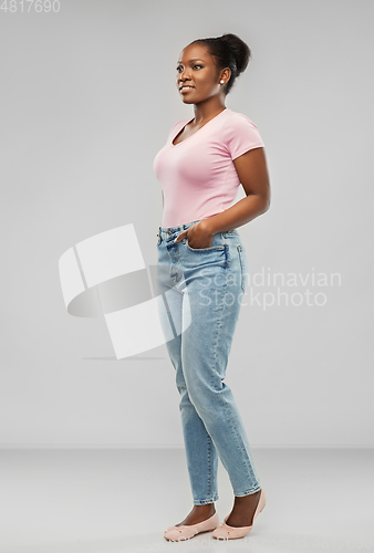Image of happy african american woman over grey background