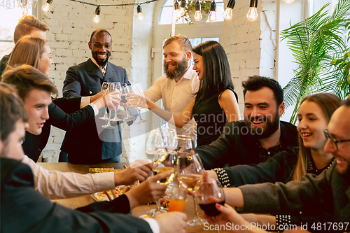 Image of Happy co-workers celebrating while company party and corporate event