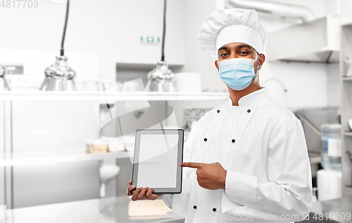 Image of male chef in face mask with tablet pc at kitchen