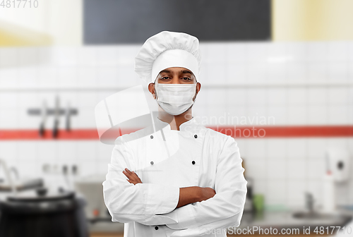 Image of male chef in face mask at restaurant kitchen