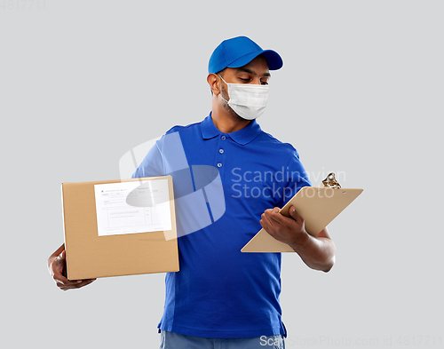 Image of delivery man in mask with parcel box and clipboard