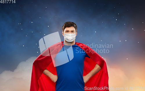 Image of superhero man in face protective mask at night