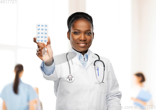 Image of african american female doctor with medicine pills