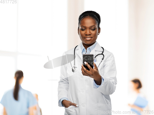 Image of african american female doctor with smartphone