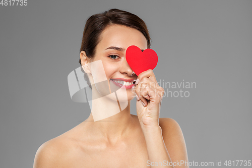 Image of beautiful woman closing one eye with pink heart