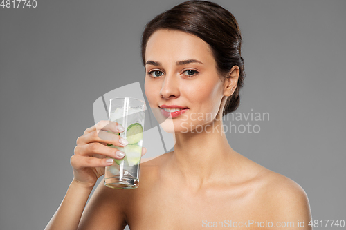 Image of woman drinking water with cucumber and ice