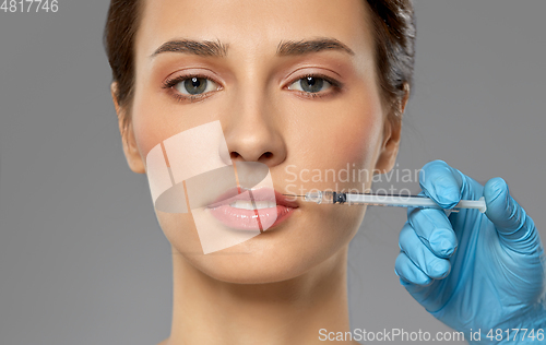 Image of beautiful young woman and hand with syringe