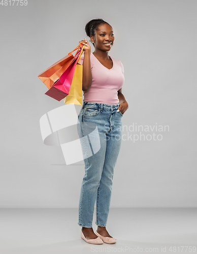 Image of happy african american woman with shopping bags