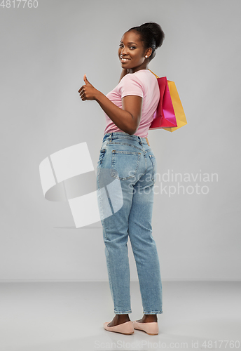 Image of happy african american woman with shopping bags