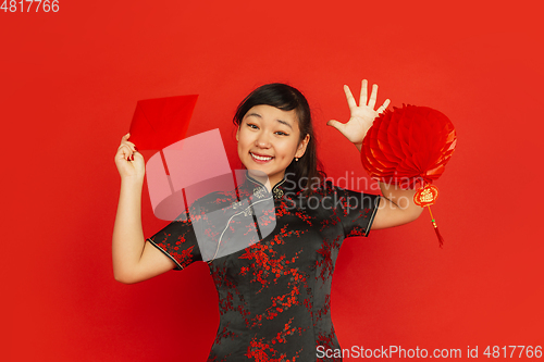 Image of Happy Chinese new year. Asian young girls\'s portrait isolated on red background