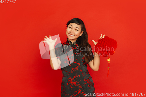 Image of Happy Chinese new year. Asian young girls\'s portrait isolated on red background