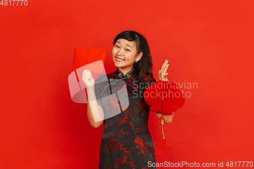 Image of Happy Chinese new year. Asian young girls\'s portrait isolated on red background