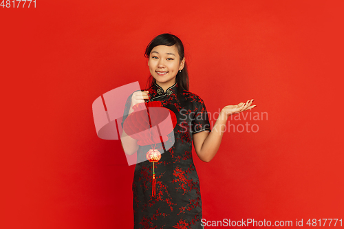 Image of Happy Chinese new year. Asian young girls\'s portrait isolated on red background