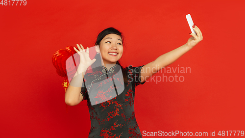 Image of Happy Chinese new year. Asian young girls\'s portrait isolated on red background