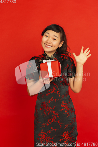 Image of Happy Chinese new year. Asian young girls\'s portrait isolated on red background