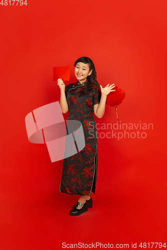 Image of Happy Chinese new year. Asian young girls\'s portrait isolated on red background