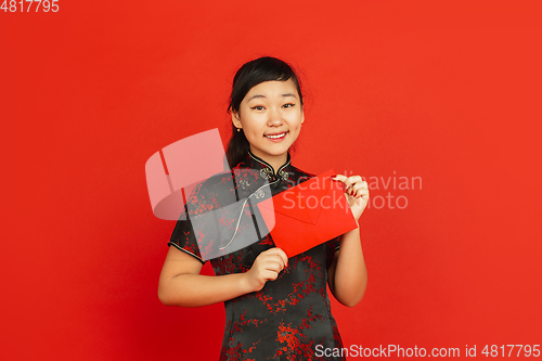 Image of Happy Chinese new year. Asian young girls\'s portrait isolated on red background