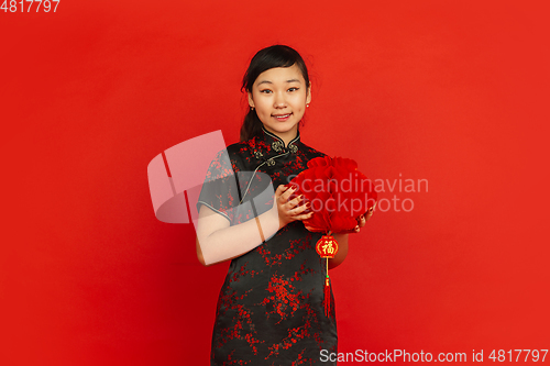 Image of Happy Chinese new year. Asian young girls\'s portrait isolated on red background