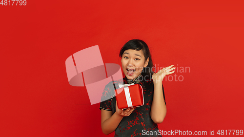 Image of Happy Chinese new year. Asian young girls\'s portrait isolated on red background