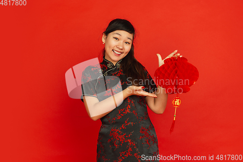 Image of Happy Chinese new year. Asian young girls\'s portrait isolated on red background