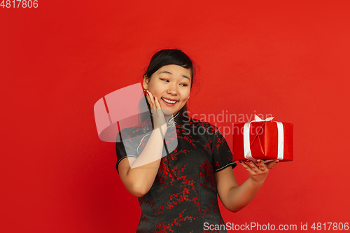 Image of Happy Chinese new year. Asian young girls\'s portrait isolated on red background