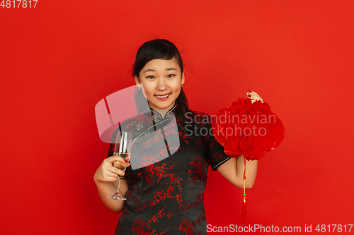 Image of Happy Chinese New Year. Asian young girls\'s portrait isolated on red background