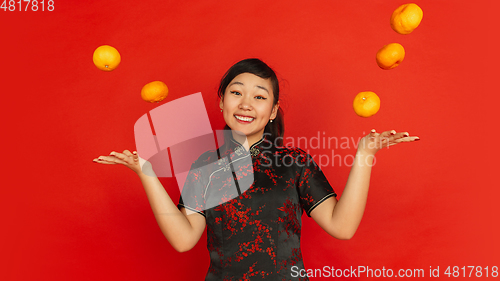 Image of Happy Chinese New Year. Asian young girls\'s portrait isolated on red background
