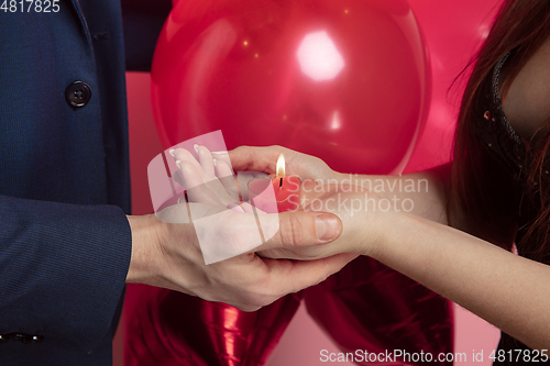 Image of Valentine\'s day celebration, happy caucasian couple isolated on coral background