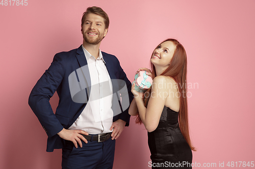 Image of Valentine\'s day celebration, happy caucasian couple isolated on coral background