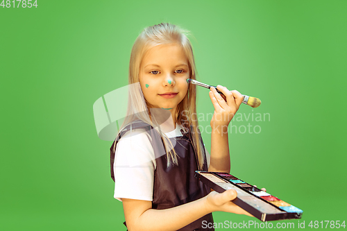 Image of Little girl dreaming about future profession of makeup artist