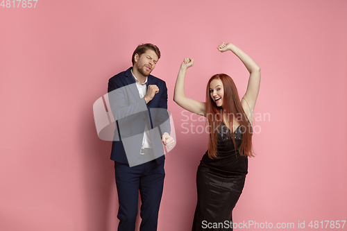 Image of Valentine\'s day celebration, happy caucasian couple isolated on coral background