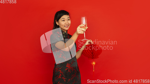 Image of Happy Chinese New Year. Asian young girls\'s portrait isolated on red background