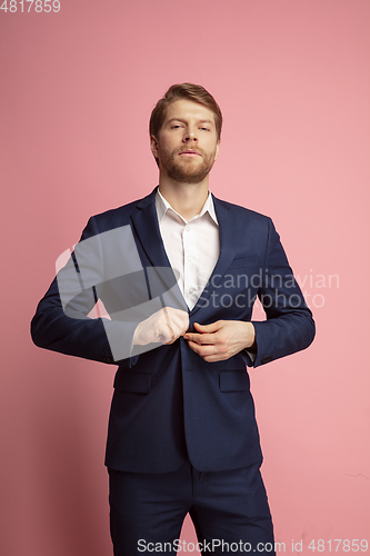 Image of Portrait of young caucasian man isolated on coral background