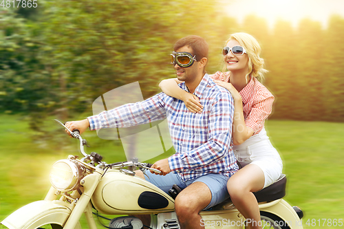 Image of beautiful couple on retro motorbike