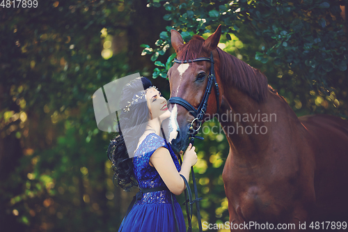 Image of beautiful girl in dress with horse