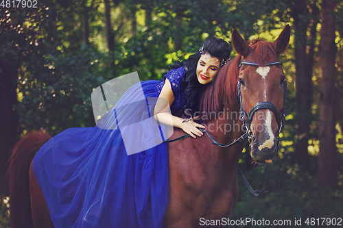 Image of beautiful girl in dress with horse