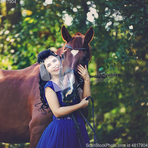 Image of beautiful girl in dress with horse